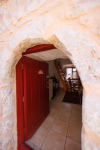an entrance to a room with a red door at LITHOS TRADITIONAL TOWER in Areopoli