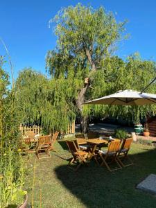 a group of tables and chairs with an umbrella at Wein & Landhaus Willi Opitz in Illmitz