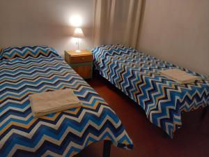 dwa łóżka siedzące obok siebie w pokoju w obiekcie Casa Eusebio - Catamarca capital w mieście San Fernando del Valle de Catamarca