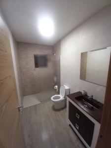 a bathroom with a toilet and a sink at Los Pinos Munera in Munera +9 photos