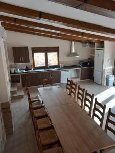 a kitchen with a long wooden table and chairs at Los Pinos Munera in Munera