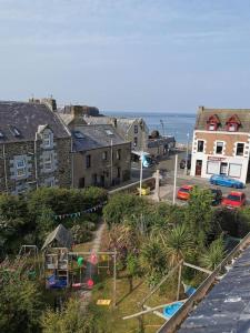 a view of a town with a playground and the ocean at Driftwood in Eyemouth