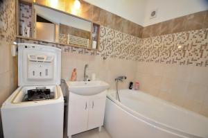 a bathroom with a sink and a bath tub at Dream apartment in Bratislava