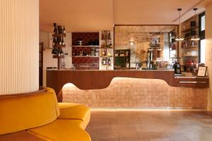 a lobby with a couch and a bar at Kraft Hotel in Paris