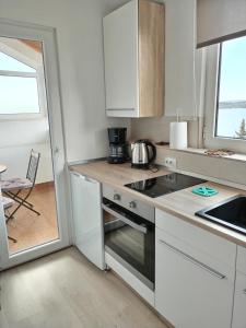 a small kitchen with a stove and a sink at Ana Apartment in Šibenik