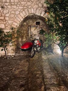 a red motorcycle parked in a stone tunnel at Barone Gambadoro in Monte SantʼAngelo