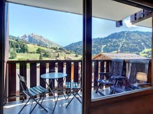 a balcony with chairs and a table with a view at Résidence RS0223 Bat.2 in La Clusaz