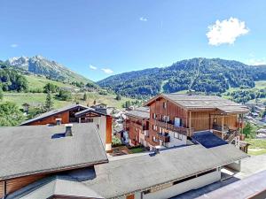 an aerial view of a house with mountains in the background at Résidence RS0223 Bat.2 in La Clusaz