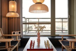 a room with a table with a vase on it at CPH Hotel in Copenhagen