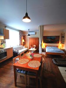 uma sala de estar com uma mesa e um quarto com uma cama em Mazurskie Klimaty - niezależny, ogrodzony dom em Wydminy