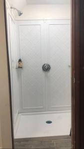 a shower with a glass door in a bathroom at room with a private shower in Arlington