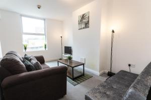 a living room with a couch and a table at April Disc - Long Stay - Contractors in Bristol