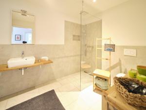 a bathroom with a sink and a shower at Hof Maiholm - Sattelkammer in Medelby +4 photos