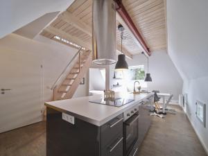 a kitchen with a counter top and a staircase at Hof Maiholm - Heuboden in Medelby