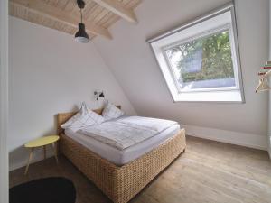 a bedroom with a wicker bed and a window at Hof Maiholm - Heuboden in Medelby