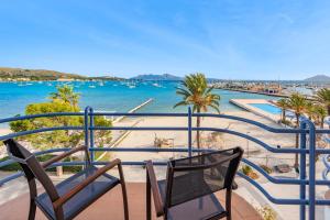 a balcony with two chairs and a view of the water at NEW Seaview Ap Anita by JS Villas in Port de Pollensa
