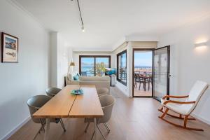 a living room with a table and a couch at NEW Seaview Ap Anita by JS Villas in Port de Pollensa