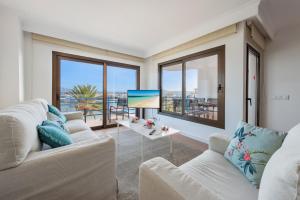 a living room with two couches and a large window at NEW Seaview Ap Anita by JS Villas in Port de Pollensa