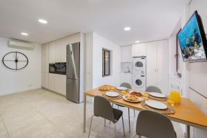 a kitchen and dining room with a table and chairs at NEW Seaview Ap Anita by JS Villas in Port de Pollensa