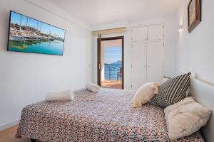 a bedroom with a bed with a stuffed animal on it at NEW Seaview Ap Anita by JS Villas in Port de Pollensa