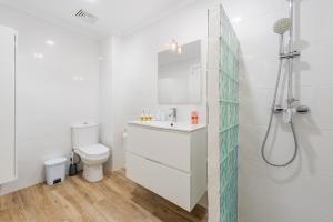 a white bathroom with a shower and a toilet at NEW Seaview Ap Anita by JS Villas in Port de Pollensa