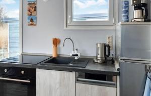 a small kitchen with a sink and a refrigerator at 1 Bedroom Beach Front Ship In Havelsee Ot Ktzkow 