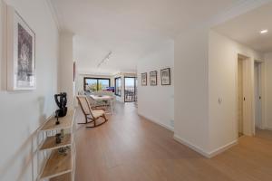 a white hallway with a table and a dining room at NEW Seaview Ap Anita by JS Villas in Port de Pollensa