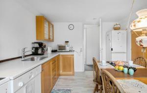 uma cozinha com um lavatório e uma mesa com cadeiras em 3 Bedroom Lovely Apartment In Engesvang em Engesvang