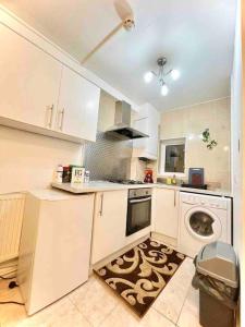 a kitchen with a washing machine and a washer at Great Studio flat in Central London in London