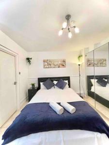 a bedroom with a large bed with two pillows at Great Studio flat in Central London in London