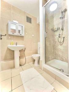 a bathroom with a sink and a shower and a toilet at Great Studio flat in Central London in London