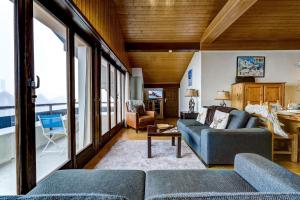 a living room with two blue couches and a table at Penthouse 36 Savoleyres in La Tzoumaz +22 photos