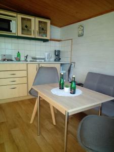 a table with two bottles on it in a kitchen at FEWO Isla 2 in Elmenhorst