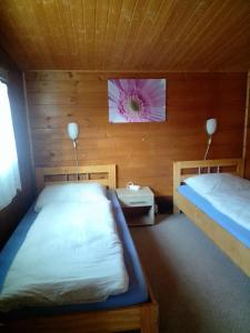 a bedroom with two beds and a flower on the wall at FEWO Isla 2 in Elmenhorst