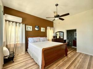 a bedroom with a bed and a ceiling fan at Villa Jaden #2 in Road Town