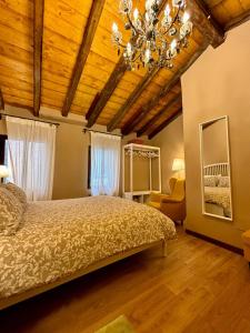 a bedroom with a bed and a chandelier at Incantevole Casetta Veneziana in Venice