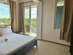 a bedroom with a bed and a large window at Slipway Seaview in Dar es Salaam