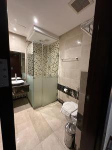 a bathroom with a shower and a toilet and a sink at فندق الشهباء جده Al Shahba Jeddah in Jeddah