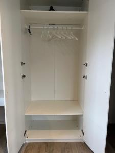 a white walk in closet with white cabinets at Sint-Amandstraat studio B4 in Ghent