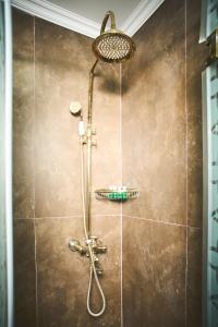 a shower with a shower head in a bathroom at Xan Hotel in Baku