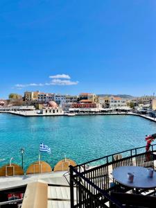 a large body of water with a city in the background at Erietta Suites in Chania
