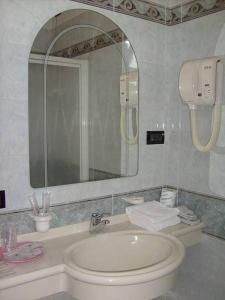 a bathroom with a sink and a mirror at Hotel Motel Flower in Novi Ligure