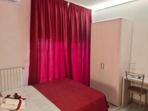 a bedroom with a pink curtain and a bed at Bed End Breakfast Mary's Tower in Bologna