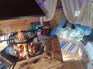 an inside view of a fire in a tent at Private Lakeside Retreat in Renac