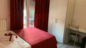 a bedroom with a bed with a red blanket at Bed End Breakfast Mary's Tower in Bologna