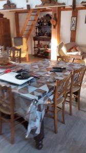 a dining room table with chairs and a table cloth at La Grange de Marcel in Retournac