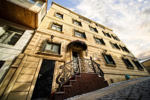 a building with a staircase on the side of it at Xan Hotel in Baku