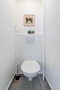 ein Bad mit einem WC und einem Bild an der Wand in der Unterkunft Charmant appartement calme place du Trocadéro - 4P in Paris