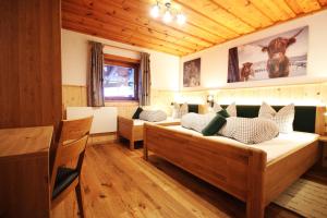 a bedroom with two beds in a room with wooden ceilings at Almliesl ALTZ-718 in Altenmarkt im Pongau