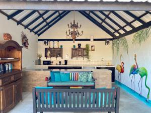 a kitchen with a bench in the middle of a room at Casa Amalia in Willemstad